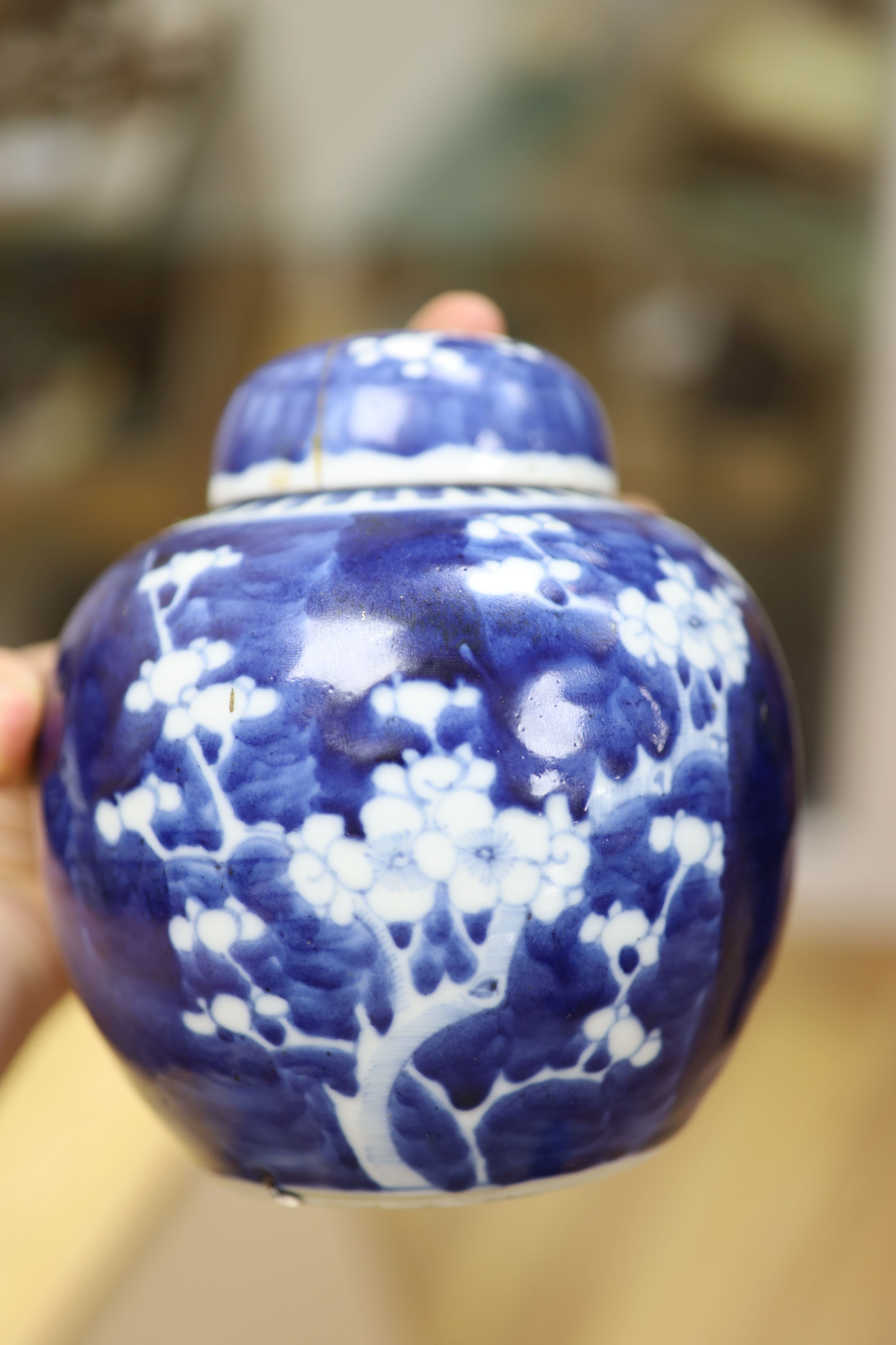 Two Chinese blue and white prunus pattern ginger jars and a similar cylinder vase, tallest 26cm